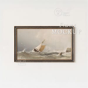 May include: A framed artwork depicting a sailboat navigating rough seas. The painting features a dark wooden frame and the text "Frame MOCKUP" in white. The image has a 16:9 ratio.