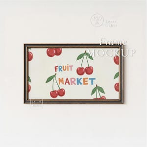 May include: A framed print with a black border featuring a "Fruit Market" design. The artwork showcases red cherries with green leaves and the words "Fruit Market" in colorful letters on a cream background.