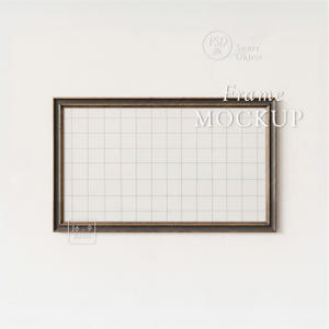 May include: Rectangular frame mockup with a dark brown distressed wood-look border. The frame has a white grid pattern inside. The words "Frame MOCKUP" are displayed in white text. The aspect ratio is 16:9.