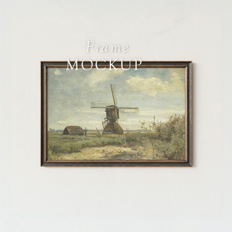 May include: Framed landscape art print featuring a windmill, a small building, and a person in a field. The artwork has a vintage aesthetic with a dark brown frame and the text "Frame MOCKUP" at the top.
