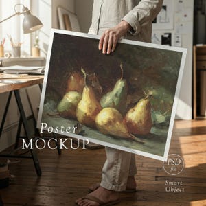 May include: A person holding a poster mockup featuring a still life painting of pears. The pears are yellow and green, with brown stems and leaves. The poster has the words "Poster MOCKUP" printed on it.