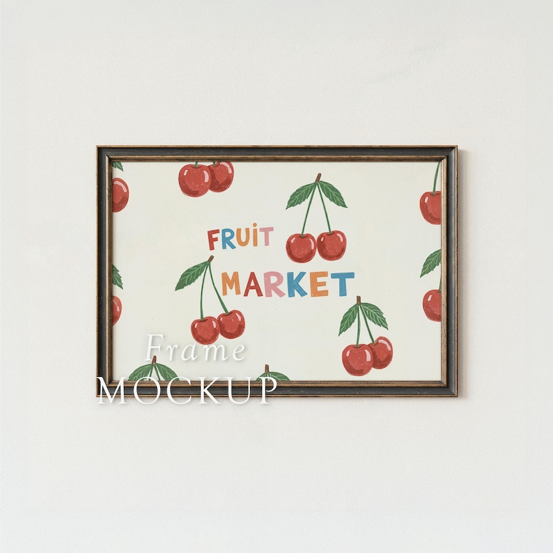 May include: A framed print featuring a repeating pattern of red cherries with green leaves on a cream background. The words "FRUIT MARKET" are in colorful letters. The frame is dark brown.