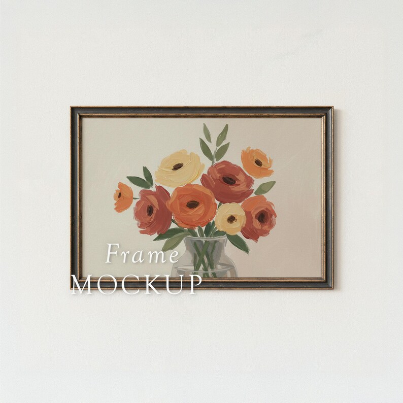 May include: A framed floral art print featuring a bouquet of orange, yellow, and red flowers in a glass vase. The artwork is set against a neutral background, with the words "Frame MOCKUP" in white text. The frame is dark brown.