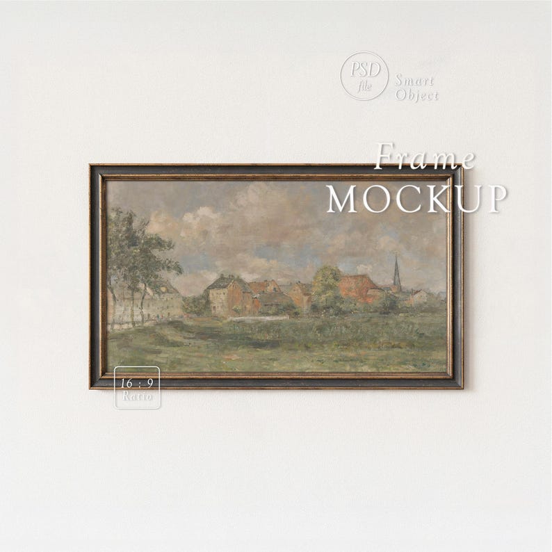 May include: A framed landscape painting with a dark wooden frame. The artwork depicts a village scene with red-roofed buildings, a church steeple, and a cloudy sky. The words "Frame MOCKUP" are displayed on the image.