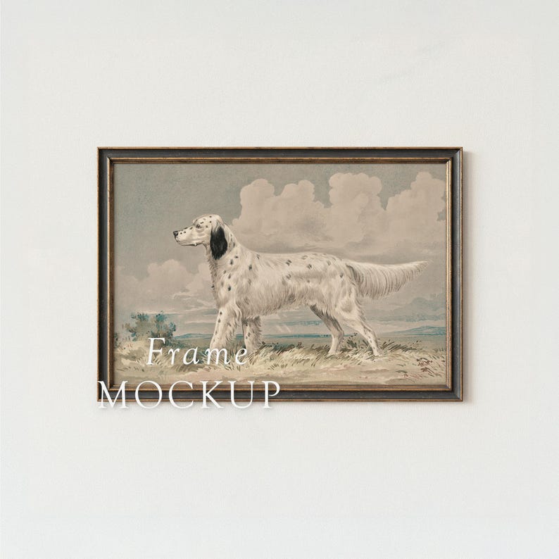 May include: A framed print featuring a white dog with black spots, set against a backdrop of a cloudy sky and grassy terrain. The artwork is in a dark brown frame, with the words "Frame MOCKUP" at the bottom.