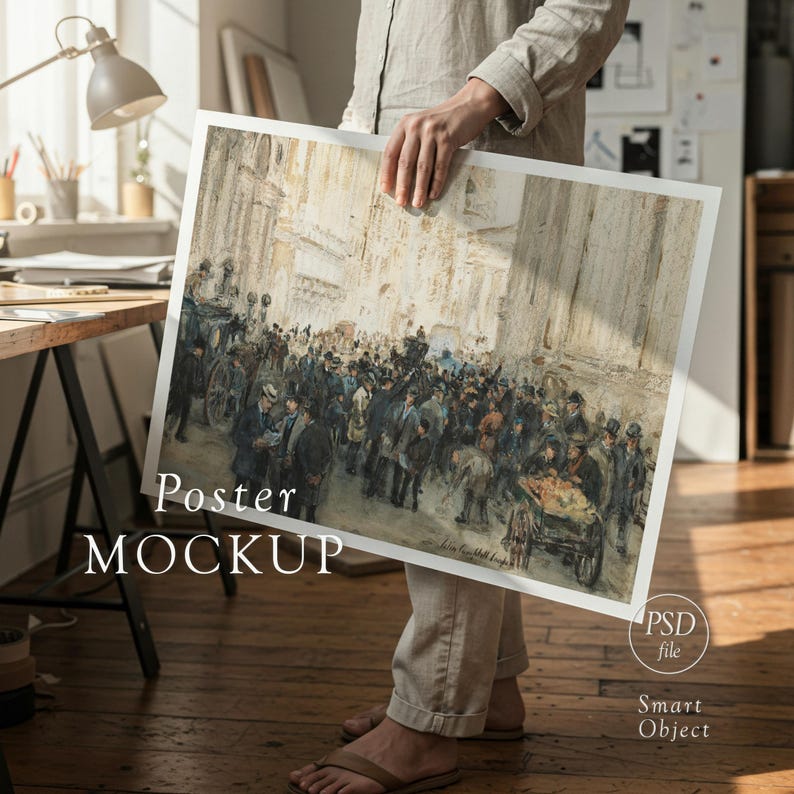 May include: A framed poster mockup featuring a vintage street scene with a crowd of people and horse-drawn carriages. The poster is held by a person. The words "Poster MOCKUP" are printed on the poster.