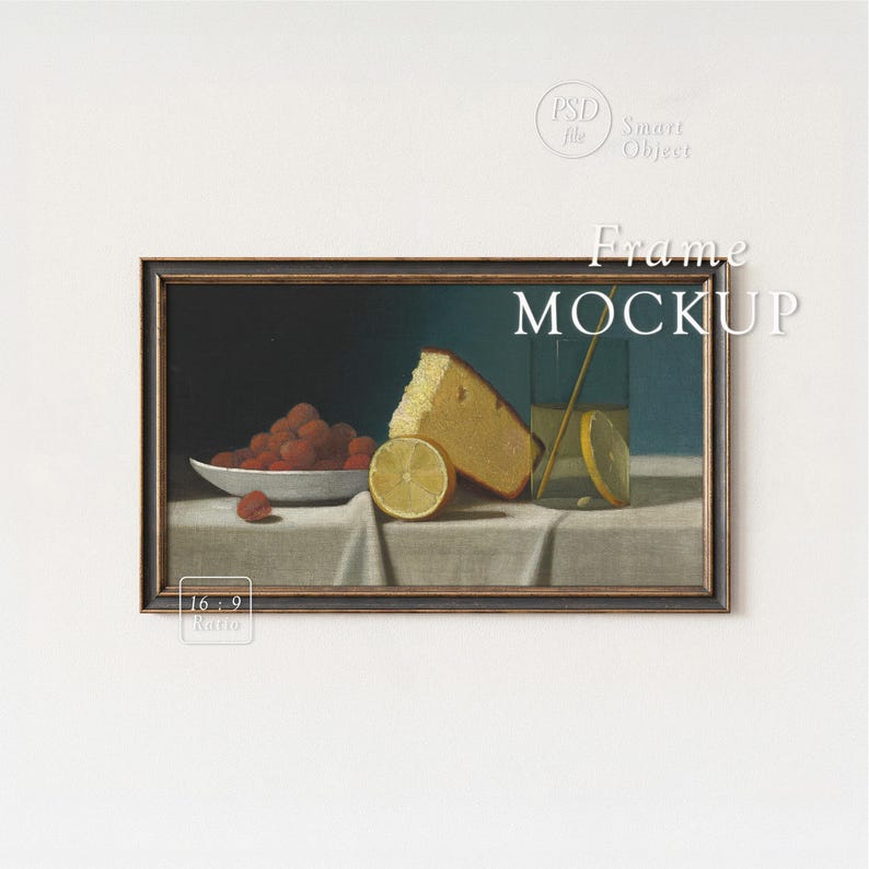 May include: A framed still life painting featuring a bowl of red raspberries, a slice of cake, and a glass with a lemon slice. The painting has a dark wooden frame and is set against a white background. The text "Frame MOCKUP" is visible.