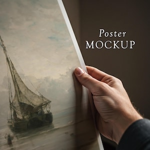 May include: A hand holds up a poster with a painting of a sailboat on a cloudy day. The poster has the text "Poster MOCKUP" at the top.