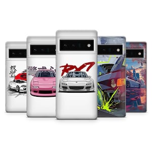 May include: A collection of white phone cases featuring car illustrations. Designs include a pink car, a white car with Japanese text and a rising sun, and a white car with the text "RX-7". The cases have a glossy finish.