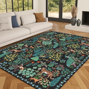 May include: A rectangular area rug with a black background and a detailed pattern of animals and foliage. The design includes tigers, deer, peacocks, and various plants in shades of green, yellow, and orange. The rug has a decorative border.