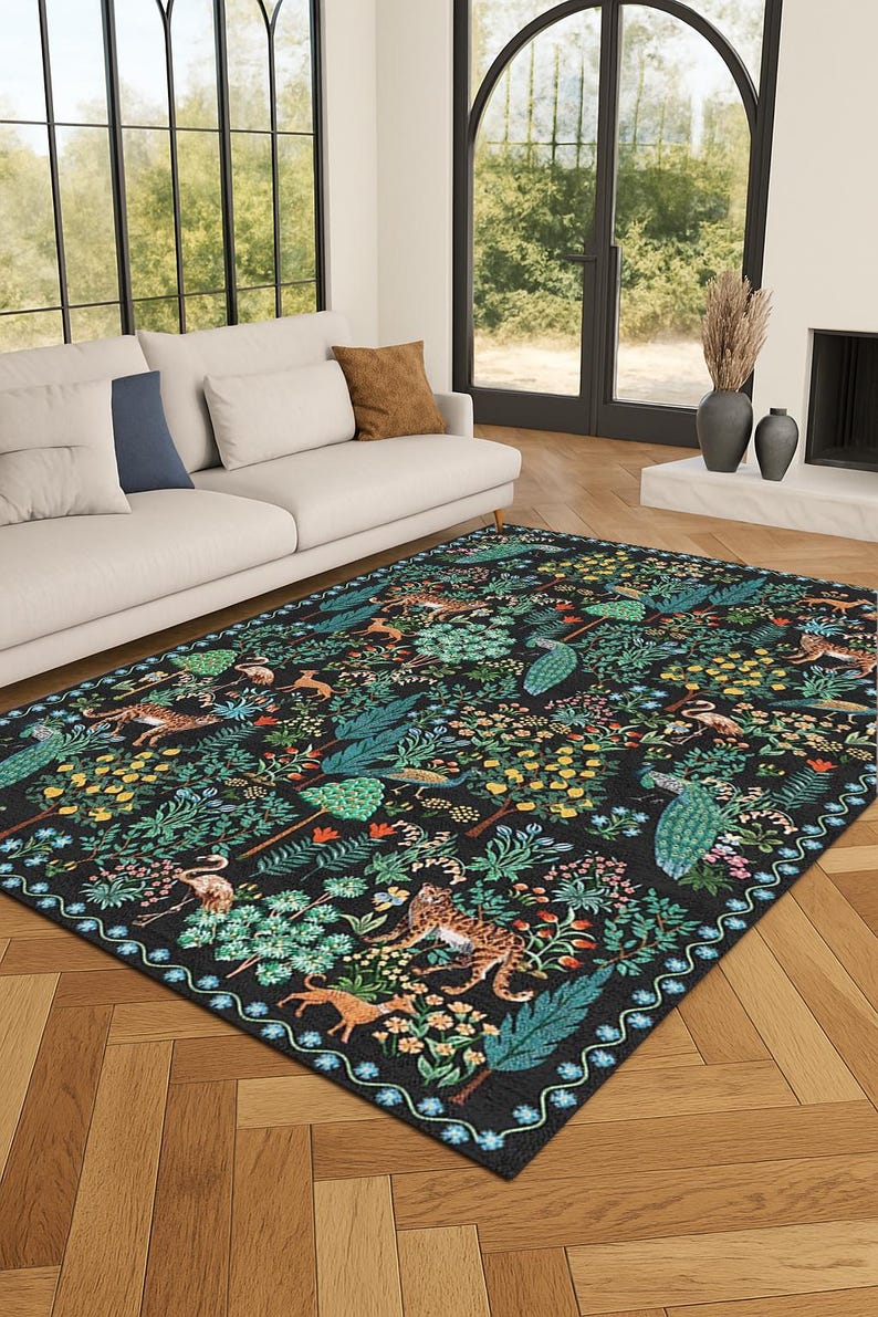 May include: A rectangular area rug with a black background and a detailed pattern of animals and foliage. The design includes tigers, deer, peacocks, and various plants in shades of green, yellow, and orange. The rug has a decorative border.