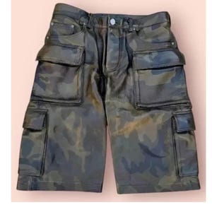 May include: Camouflage-patterned shorts with multiple cargo pockets. The shorts feature a button closure and belt loops. The fabric has a glossy finish, and the camouflage design incorporates shades of green, brown, and black.