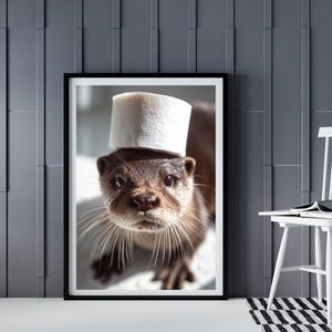 May include: A close-up of an otter wearing a white paper towel roll as a hat. The otter has brown fur and a white muzzle. The otter is looking directly at the camera.