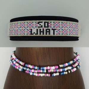 May include: A beaded bracelet with a black background and the words "So What" in white beads. A multi-strand beaded necklace with pink, white, blue, and black beads.