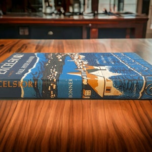 Book spine and cover laid flat – Displays title "Excelsior!" and author "Bonner" along spine with matching dust jacket design.