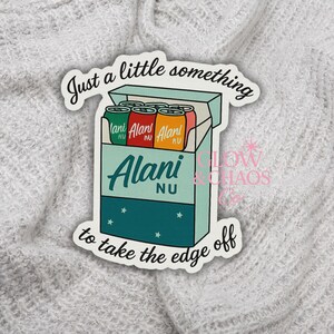 May include: A sticker featuring a teal box with six colorful cans inside. The cans are green, red, and orange with the text "Alani Nu". The sticker has the text "Just a little something to take the edge off".