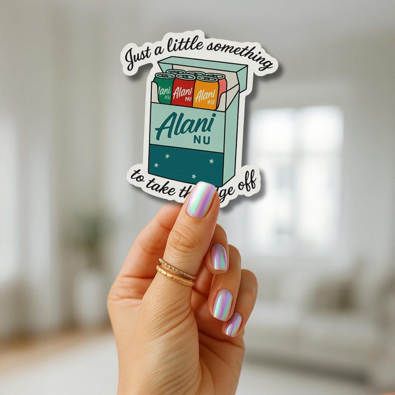 May include: A sticker featuring a cartoon illustration of a box of Alani Nu energy drinks. The box is teal with the brand name in white. The sticker has the text "Just a little something to take the edge off."