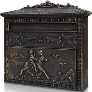 May include: Bronze-colored mailbox with a decorative roof and ornate detailing. The front panel features a relief of a person riding a horse, with mountains and birds in the background. The mailbox has a slot for mail and a door.