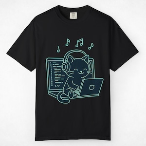 May include: A black short-sleeve t-shirt featuring a neon cyan graphic of a cat wearing headphones while using a laptop. The screen displays lines of code numbered one through twelve and a cat icon. Musical notes float above the cat's head.