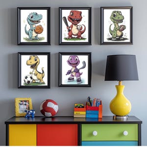 May include: Five framed prints of cartoon dinosaurs playing sports. The dinosaurs are green, red, yellow, purple, and blue. The prints are hanging on a grey wall above a dresser with a lamp and a toy car.