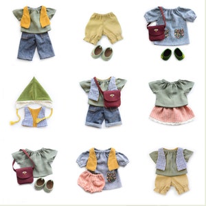 May include: Nine different doll outfits for a small doll. The outfits include a green and yellow vest, a green and white checkered vest, a green shirt, a blue shirt, a yellow skirt, a pink skirt, a pair of blue jeans, a pair of yellow pants, a pair of blue shorts, a pair of yellow shorts, a green hat, a brown purse, and a pair of green shoes.