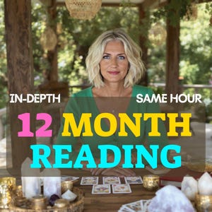 May include: A woman with blonde hair wearing a green top is seated at a wooden table. The table holds tarot cards, candles, and crystals. Text on the image reads "IN-DEPTH", "SAME HOUR", and "12 MONTH READING". The background features greenery.