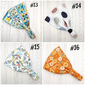 May include: Four headbands with different patterns are displayed. One has a blue and yellow tile design, another has a white background with sun-like shapes, a third has a dragonfly pattern, and the last has an orange floral print. Each headband is labeled with a number.