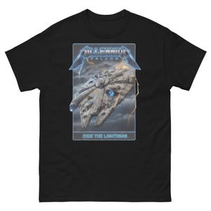 May include: Black t-shirt featuring a graphic of the Millennium Falcon spaceship with the text "MILLENNIUM FALCON" above and "RIDE THE LIGHTNING" below. The design includes lightning bolts and a stormy sky.