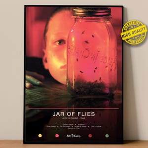 May include: Poster featuring a jar filled with insects, with the text "JAR OF FLIES" and "ALICE IN CHAINS 1994". The image has a red and black color scheme, with a person's face partially visible. The poster includes song titles.