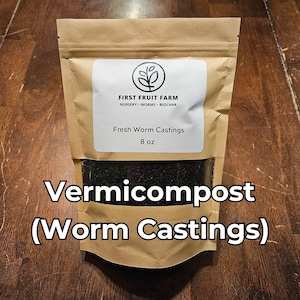 May include: A brown paper bag of vermicompost, also known as worm castings, with a clear window showing the dark, granular contents. The label reads "Fresh Worm Castings" and "8 oz". The bag is from First Fruit Farm.