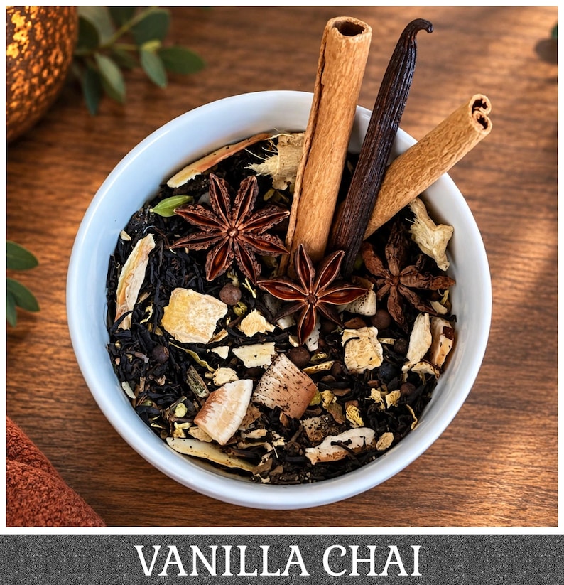 May include: A white bowl filled with loose leaf tea, featuring dark tea leaves, star anise, cinnamon sticks, a vanilla bean, and dried ginger pieces. The text VANILLA CHAI is displayed at the bottom of the image in white capital letters.