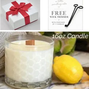 May include: A white gift box with a red ribbon, a black metal wick trimmer with text reading FREE WICK TRIMMER WITH PURCHASE OF 4 CANDLES, and a 16oz candle in a clear glass jar with a honeycomb pattern and a lemon.