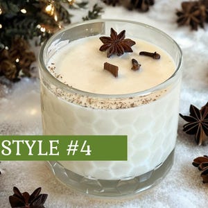 May include: A clear glass candle with a textured honeycomb pattern filled with off-white wax. The top features a wooden wick, a star anise, and two cloves. A green rectangular overlay with the white text STYLE #4 is positioned across the lower section of the glass.