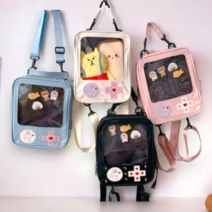 ゲーム機用痛バッグ、かわいいクリアウィンドウバックパック、アニメピンバッジディスプレイクロスボディバッグ、パステルカラーの美しいバックパック