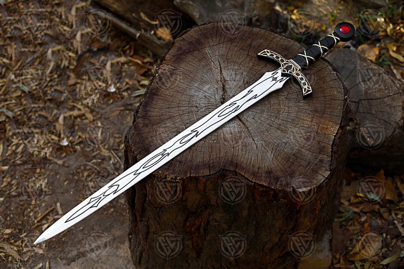 May include: A decorative sword with a silver blade and ornate black and gold hilt, resting on a weathered wooden surface. The blade features a detailed etched design. The hilt is wrapped in black leather with gold accents and a red gem at the pommel.