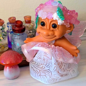 Troll Doll Fairy.  Altered vintage troll doll adorned in crystals, resin leaves, flowers, and succulents, and of course wings!