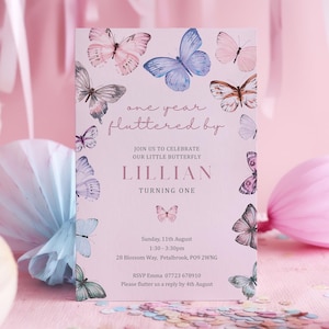 May include: A pink invitation card featuring watercolor butterflies in shades of pink, blue, and brown. The text reads "one year fluttered by" and invites guests to celebrate "our little butterfly" Lillian's first birthday. Includes date, time, and RSVP information.