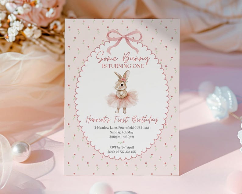 May include: A pink invitation card with a bunny illustration, text that reads "Some Bunny Is Turning One" and "Harriet's First Birthday". The card has a scalloped border and floral accents.