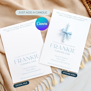 May include: Two white birthday invitations with blue text and a blue candle with a bow. The invitations read "One little candle, one little cake, one little boy to celebrate" and "Frankie turning one". The text "Digital File" and "Styling Idea" are also present.