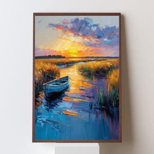 May include: A framed landscape painting depicts a serene marsh scene at sunset. The artwork features a small blue boat in a waterway, with tall grasses and a vibrant sky painted in shades of orange, yellow, and blue.