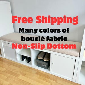 May include: White storage bench with a beige bouclé fabric cushion. The bench has multiple compartments and a non-slip bottom. The image includes text that says "Many colors of bouclé fabric".