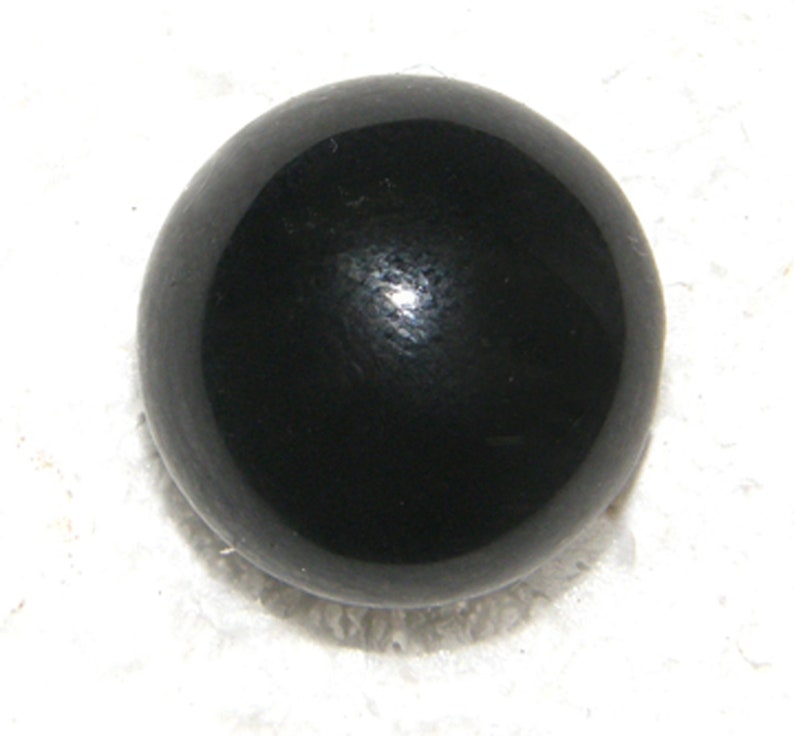 May include: A black, round, smooth, polished, glass bead.