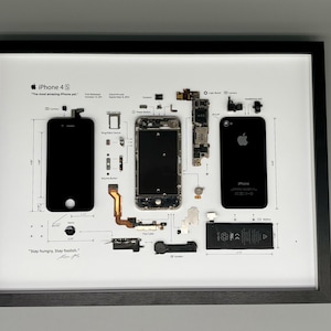 Può includere: Stampa artistica incorniciata di un iPhone 4S smontato, che mostra componenti e dimensioni. La cornice nera circonda uno sfondo bianco con le parti del telefono disposte. Il testo include "iPhone 4S" e "Stay hungry. Stay foolish."