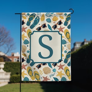 May include: A garden flag with a beach-themed pattern featuring flip-flops, sunglasses, seashells, and starfish in shades of blue, yellow, and brown. The flag has a white center with a blue border and a large letter "S".