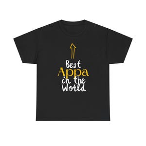 May include: Black t-shirt with white text that reads "Best Appa in the World" and a yellow arrow pointing upwards.