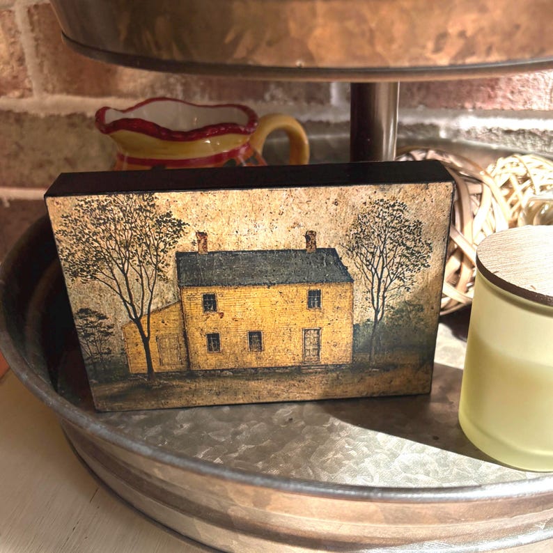 Primitive country decor block with mustard yellow colonial farmhouse artwork, distressed vintage finish, and rustic Americana style displayed on a tiered tray.