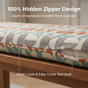 May include: Close-up of a bench cushion with a hidden zipper design. The cushion features a geometric pattern in shades of gray, teal, and orange on a cream background. The text reads "100% Hidden Zipper Design" and "Clean Look & Easy Cover Removal."