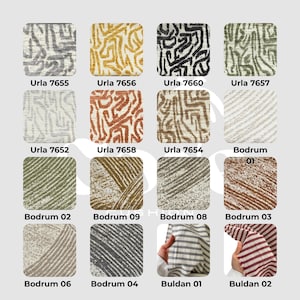 May include: A collection of fabric swatches with various patterns and colors. The swatches are labeled with names like "Urla" and "Bodrum," and feature designs including abstract lines, stripes, and textured patterns. The color palette includes gray, yellow, black, green, brown, and red.