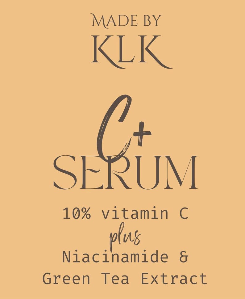 May include: A product label on a light orange background. The text reads "MADE BY KLK" in a serif font. Below, in a script font, is "C+ SERUM". Further down, it states "10% vitamin C plus Niacinamide & Green Tea Extract".
