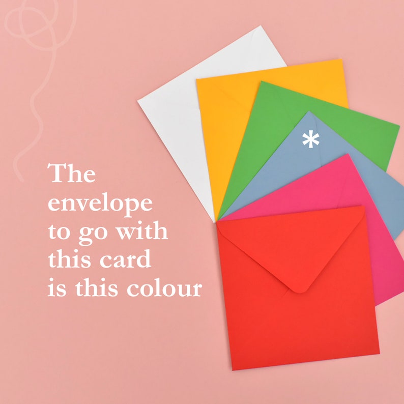 May include: A set of colourful envelopes, including red, pink, blue, green, yellow, and white, arranged in a fan shape on a pink background. The text "The envelope to go with this card is this colour" is written in white on the left side of the image.